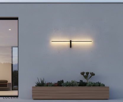 Aether sconce in rain shower showing IP54 waterproof resilience with water droplets