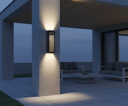 final lifestyle view of Rhea lamp glowing beside an outdoor dining table