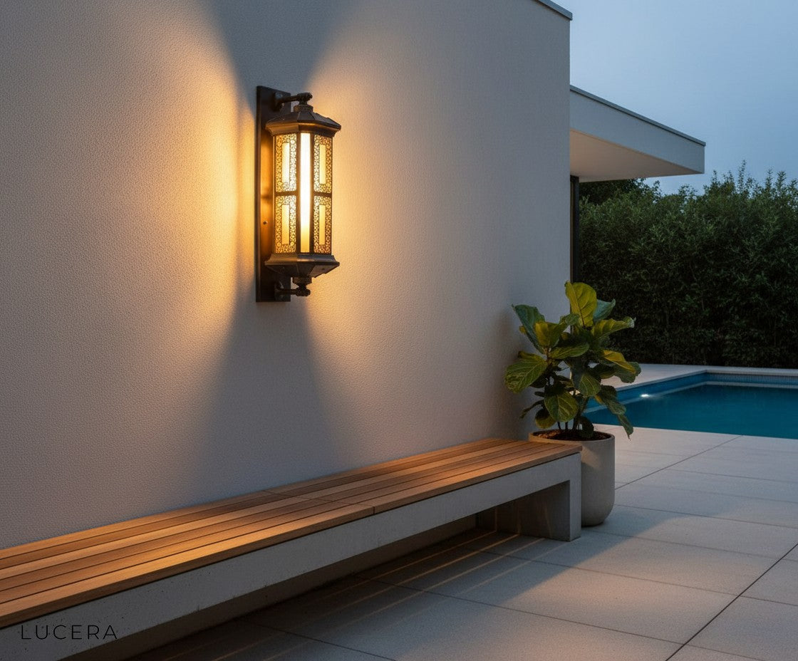 Cressida lamp casting warm light on outdoor dining table in cozy backyard setting