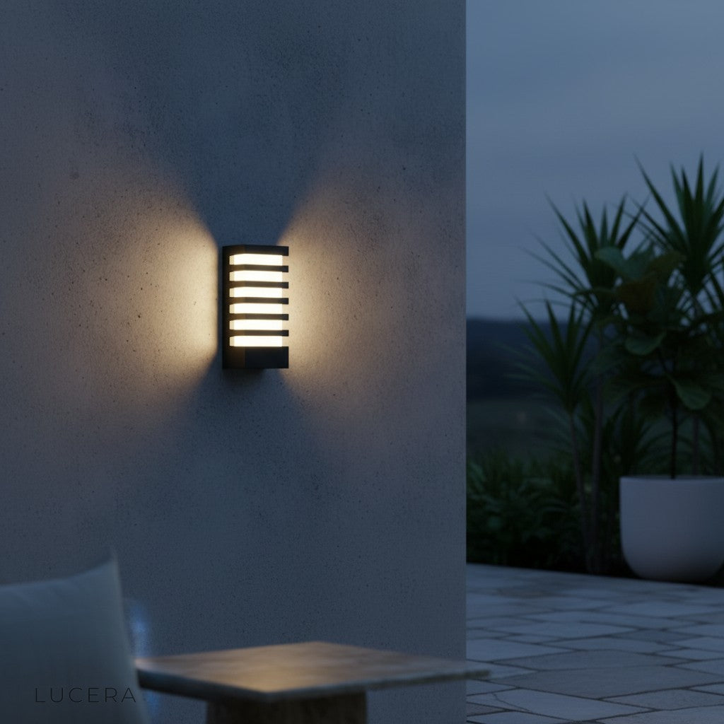 pair of Lucera wall sconces flanking a modern front door with cool white light