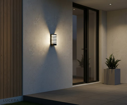 Quinn LED sconce mounted on cedar wood siding highlighting architectural detail