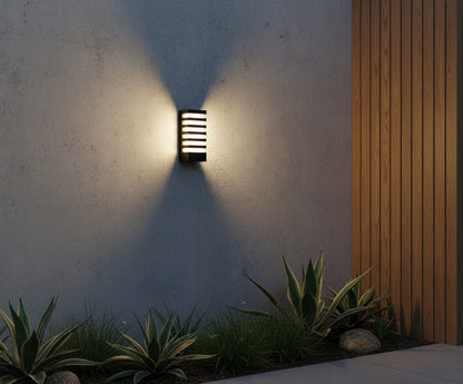 nighttime shot of Quinn sconce glowing softly above a modern house number