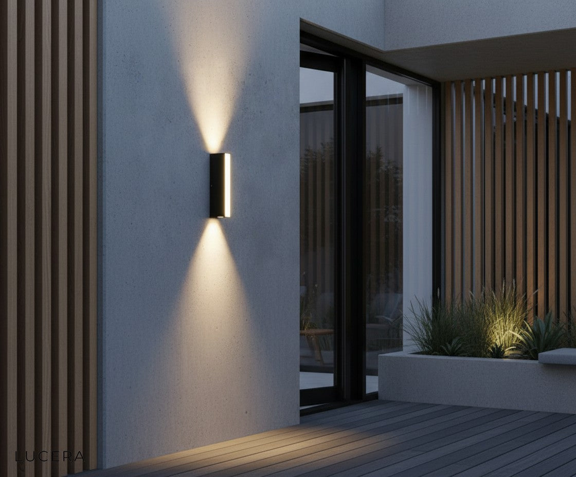 IP65 waterproof black LED wall light mounted on stone facade with rain droplets