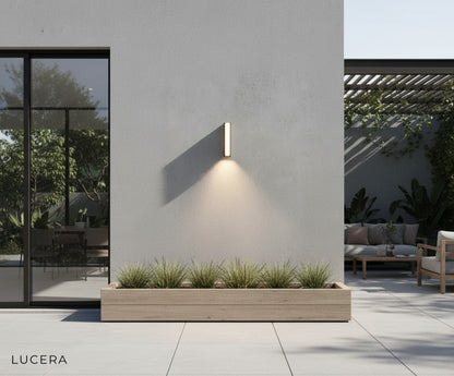 pair of black LED wall sconces flanking modern front door with warm ambiance
