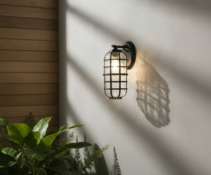 Elara wall light in a garden setting with greenery and soft dusk illumination