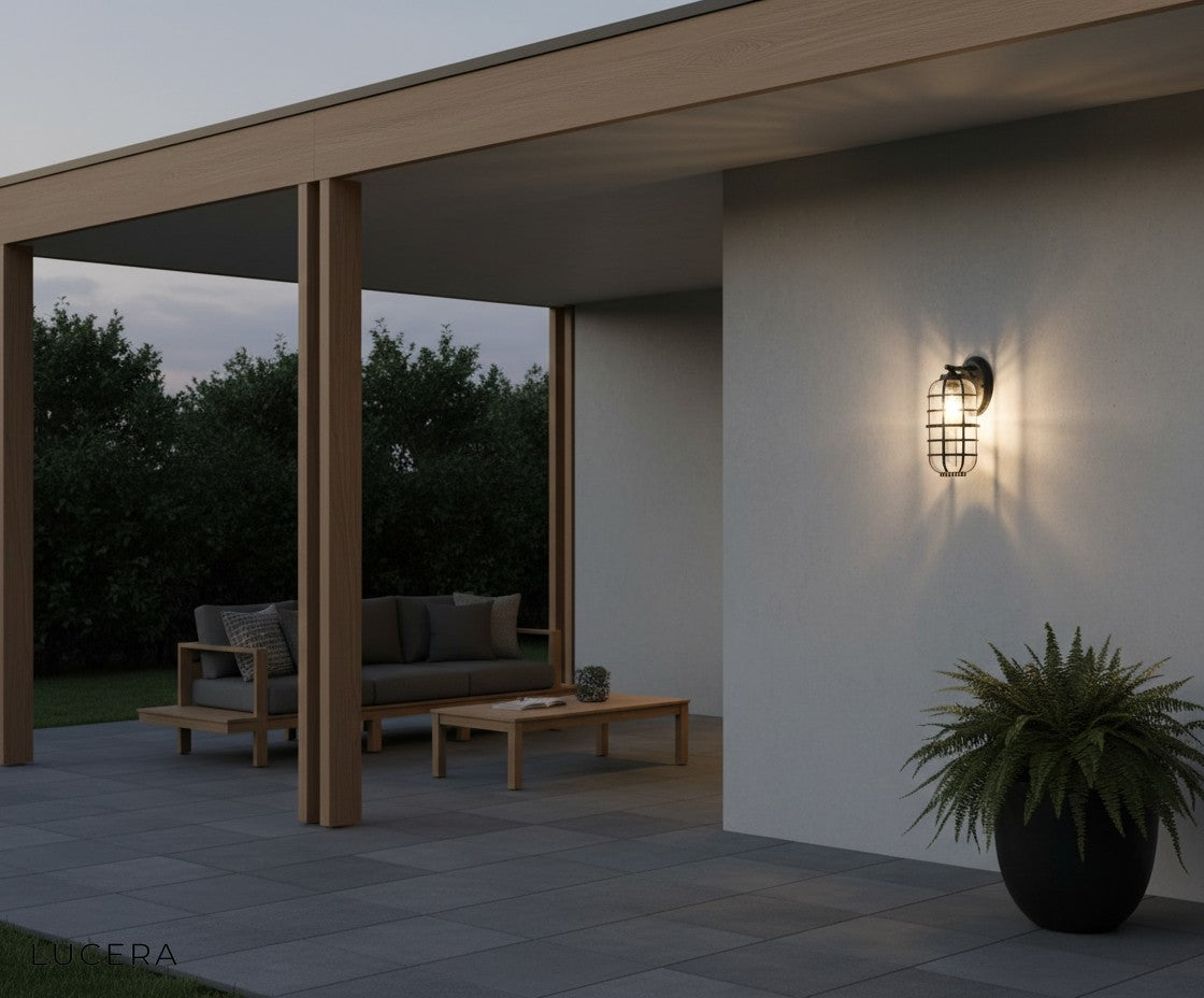 Elara outdoor light glowing against a dark exterior wall with elegant contrast