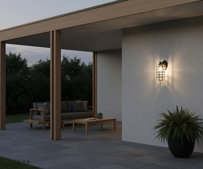 Elara outdoor light glowing against a dark exterior wall with elegant contrast