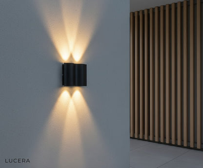 Outdoor LED wall lamp glowing softly on a modern terrace with concrete texture