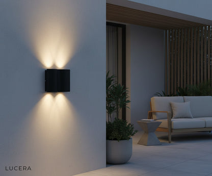 Sable Black outdoor wall lamp on a minimalist porch with ambient nighttime lighting