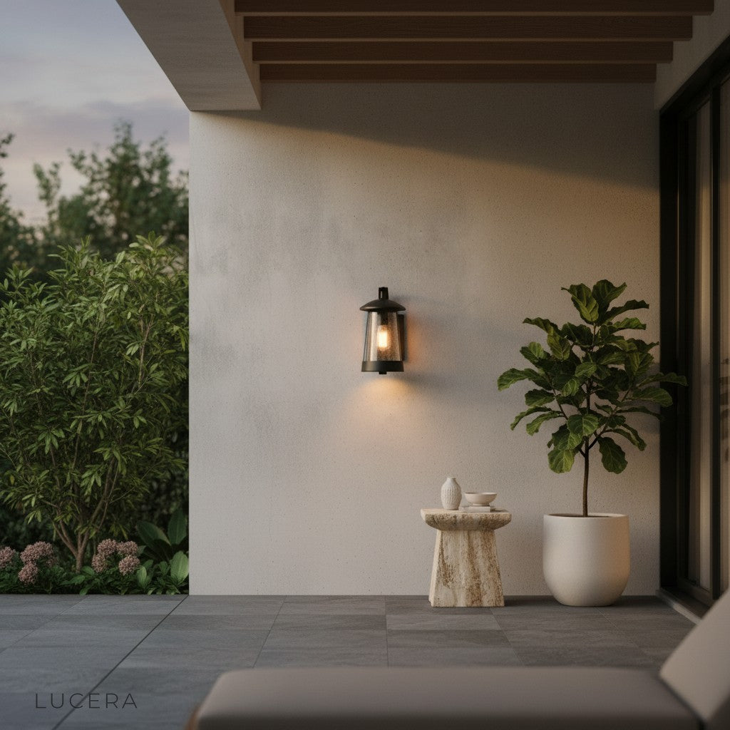 Camille LED wall light cool white glow on a minimalist stucco facade