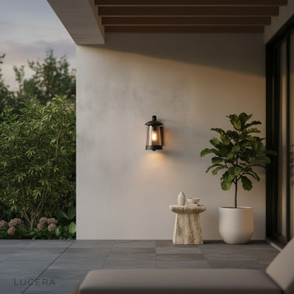 Camille LED wall light cool white glow on a minimalist stucco facade