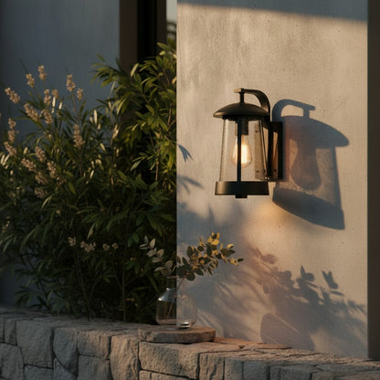Pair of Camille outdoor sconces flanking a wooden entry door in evening light