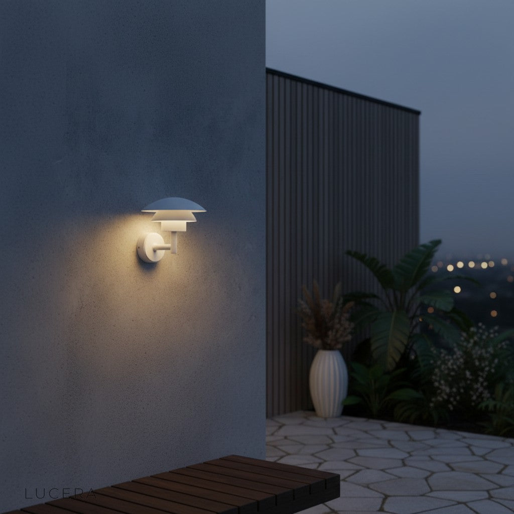 Delphine Outdoor LED Light warm white glow against dark brick wall in backyard