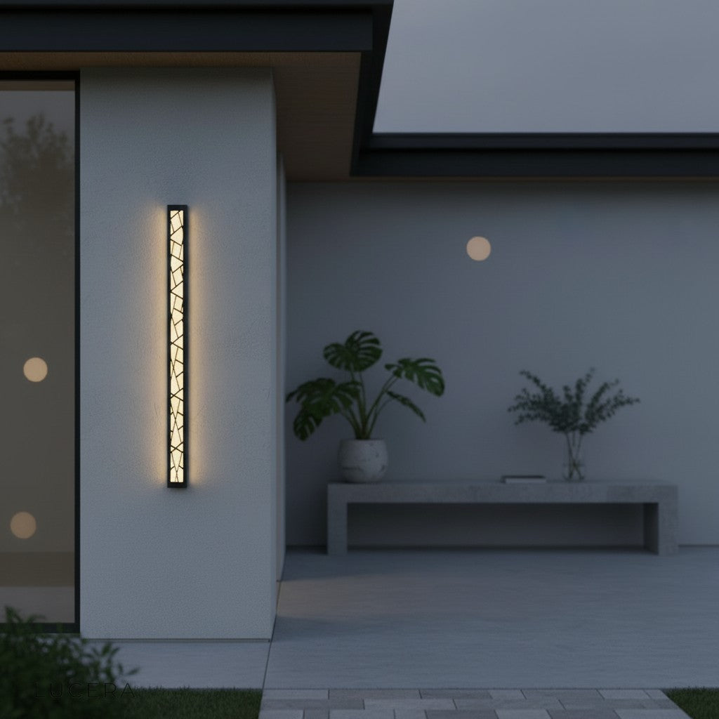 Nighttime ambiance with Giselle lamp highlighting stone facade texture
