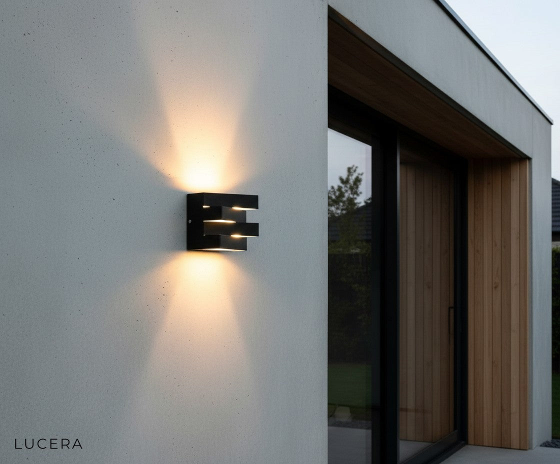 weatherproof Heline fixture glowing softly on a brick wall under eaves