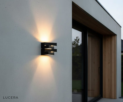 weatherproof Heline fixture glowing softly on a brick wall under eaves