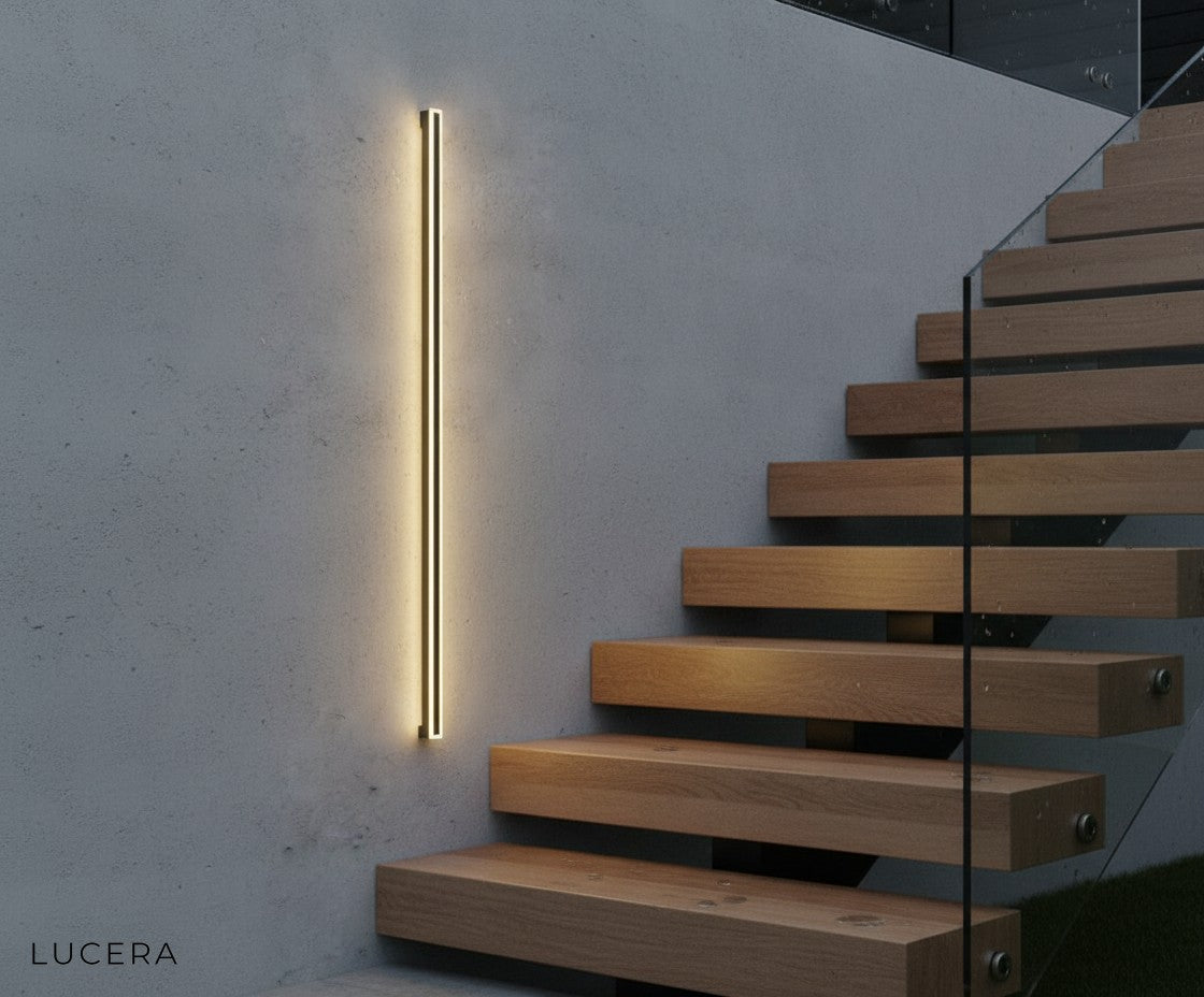 aesthetic evening scene of Odette tall wall lamp glowing against wooden slat exterior wall