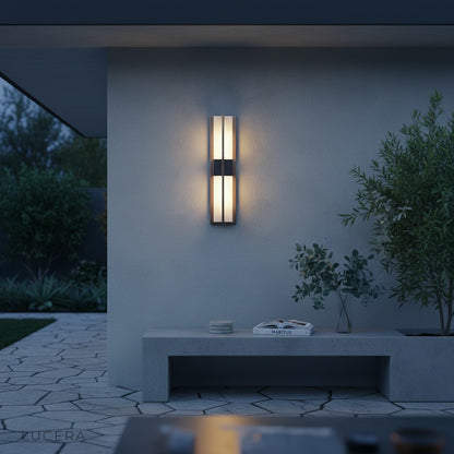 side angle of black and copper LED sconce showing slim profile and warm 3000K glow