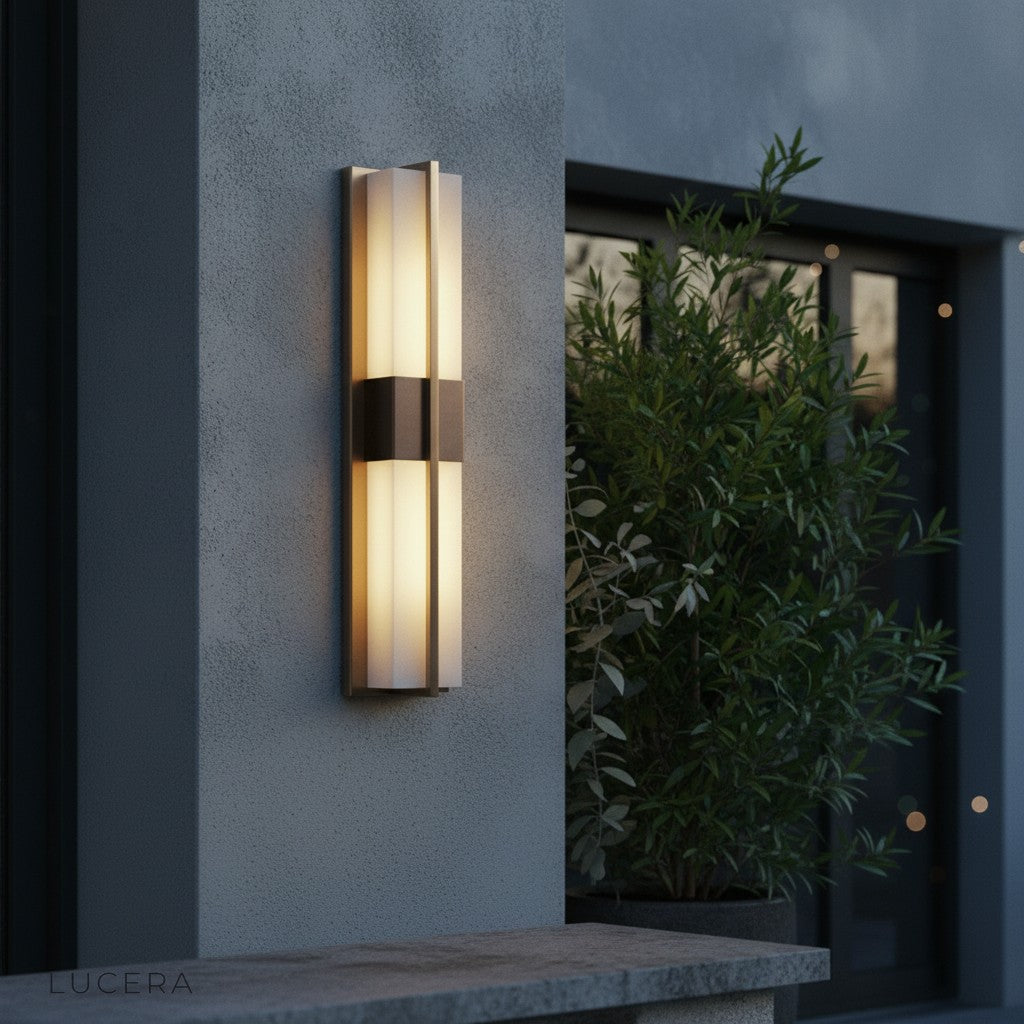 black copper wall light mounted on brick exterior with soft evening shadows and warm ambient lighting