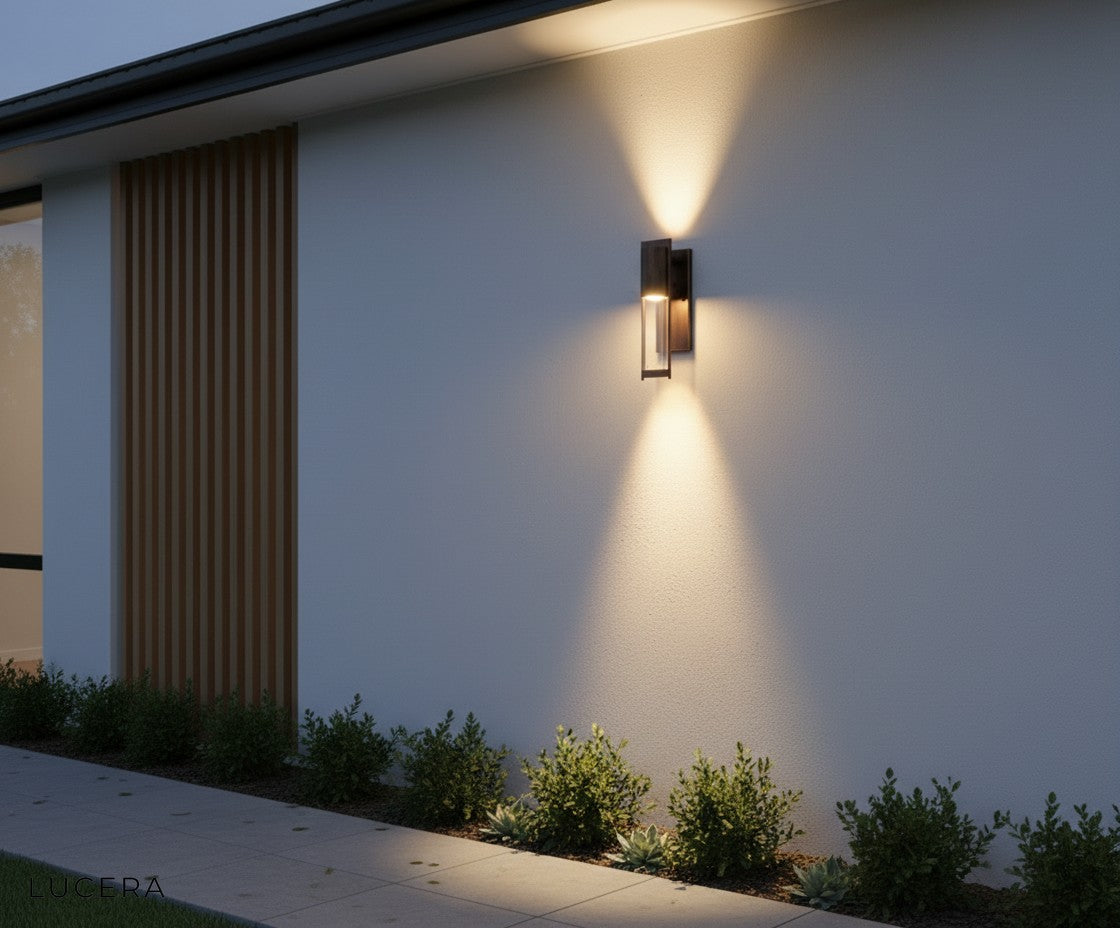 Aesthetic evening shot of the Viviane LED wall light casting inviting shadows on a textured wall