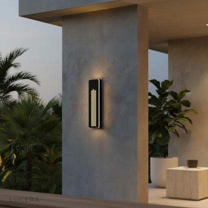 pair of Willa LED wall lamps flanking a modern front door with cool white light at night