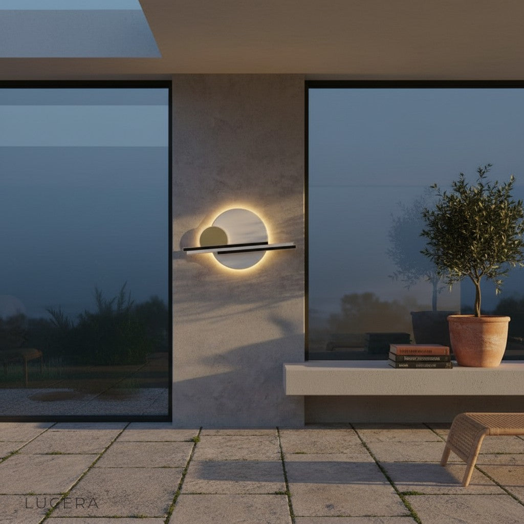 nighttime shot of Zola wall lamp illuminating a dark stone facade with warm light