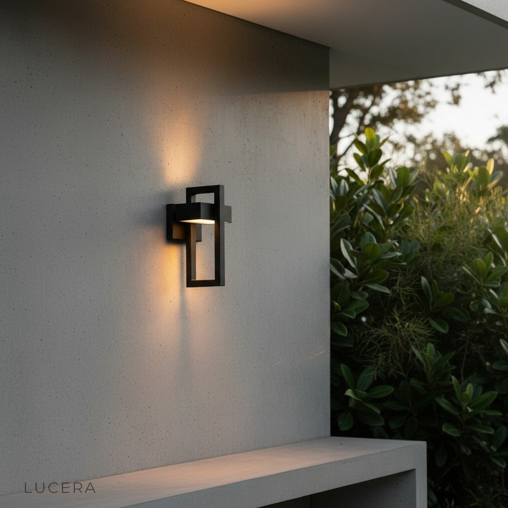 IP65 rated LED wall light glowing against weathered wood siding