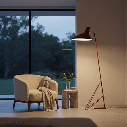 tripod floor lamp with architectural silhouette against white wall