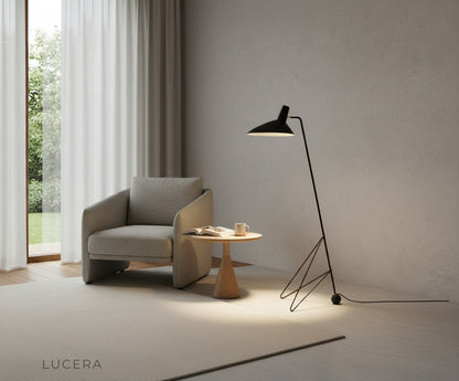 nighttime shot of sculptural floor lamp glowing in dark living room