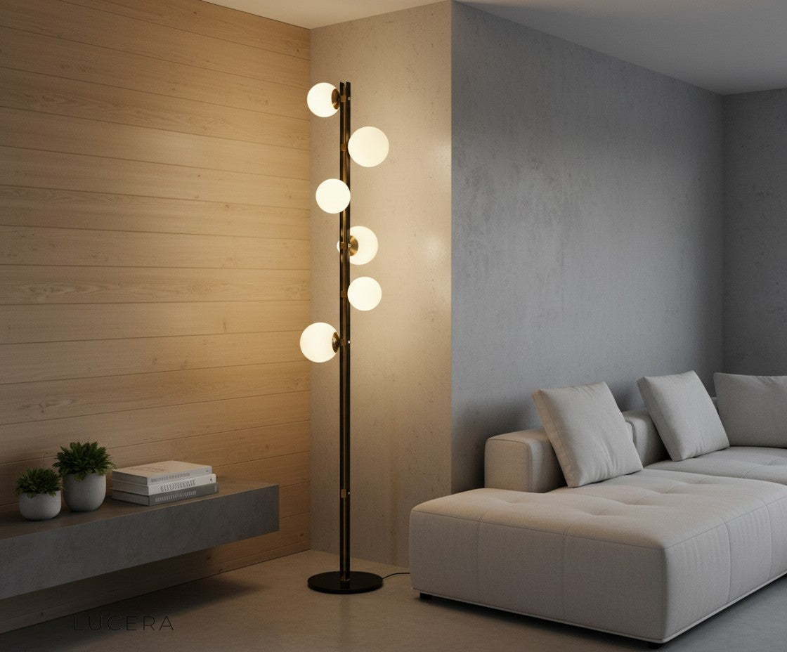 Opal glass globe floor lamp glowing at dusk in elegant entryway with plants