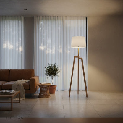 Spinel Boudry floor lamp with cloth shade next to bookshelf in minimalist home office