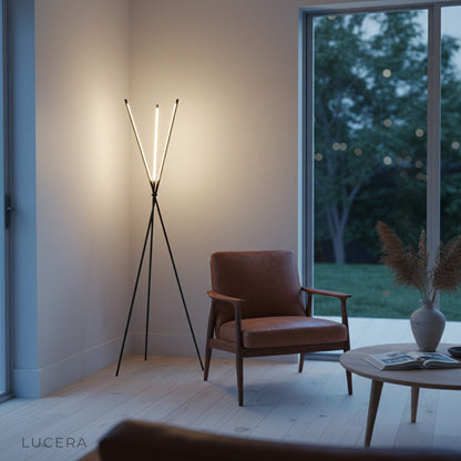 black geometric LED floor lamp casting cool white light in modern studio setting