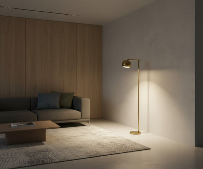 Gold floor lamp with iron base adding sophistication to contemporary lounge