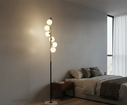 sculptural floor lamp illuminating entryway with glass ball details