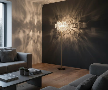 copper and crystal floor lamp beside armchair in stylish minimalist home office