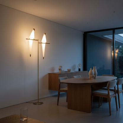 nighttime ambient shot of parrot floor lamp glowing warmly in a dark stylish bedroom