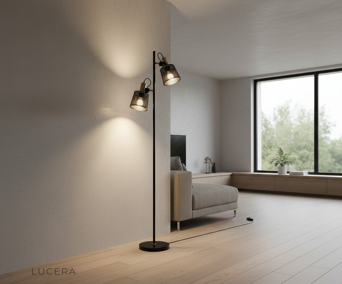black metal floor lamp in dark room with dramatic warm glow highlighting sleek silhouette