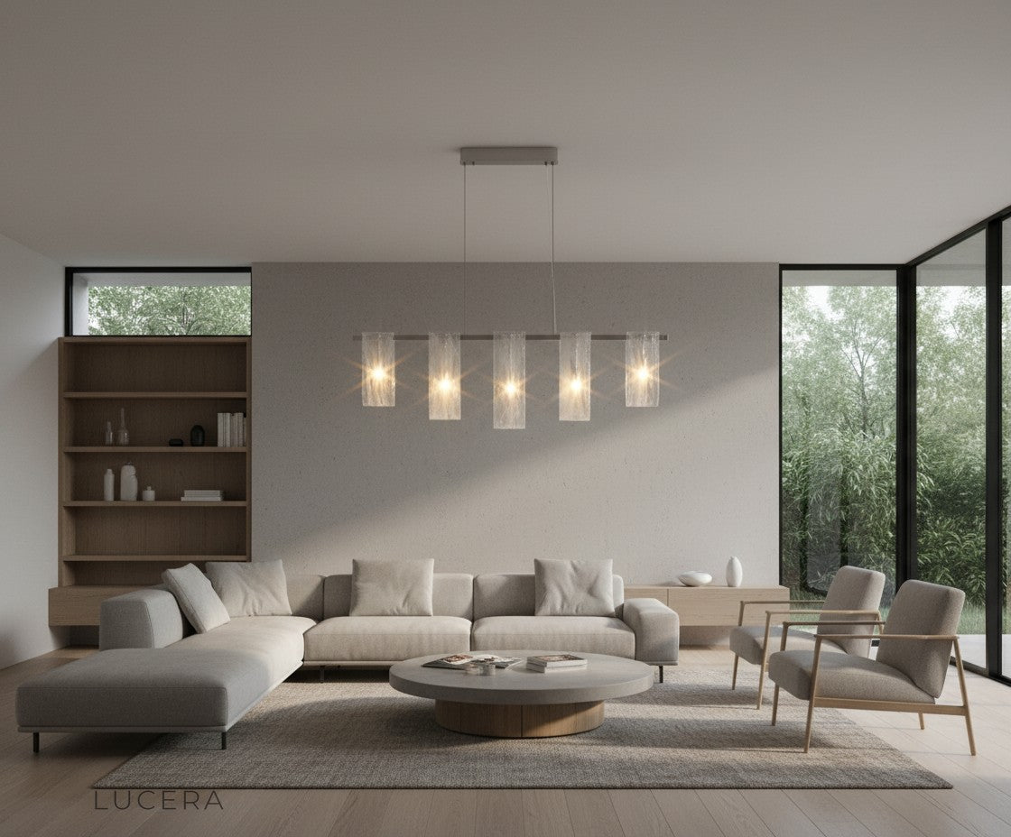 Fuchsia Liora linear pendant light casting even illumination over a long dining table with glassware
