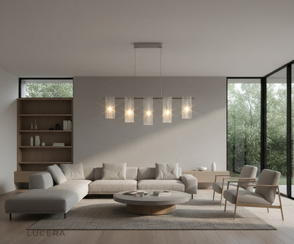 Fuchsia Liora linear pendant light casting even illumination over a long dining table with glassware