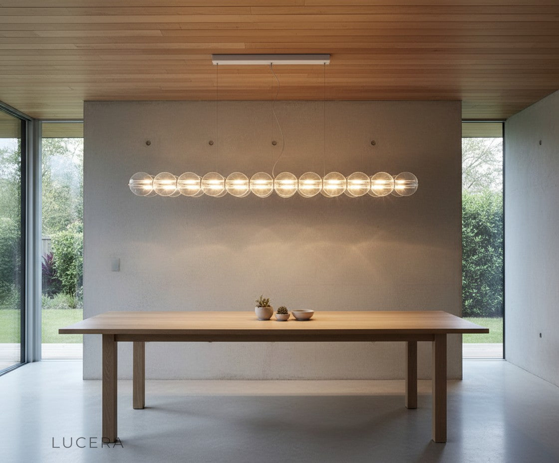Vermeil pendant light casting ethereal glow in a minimalist hallway
