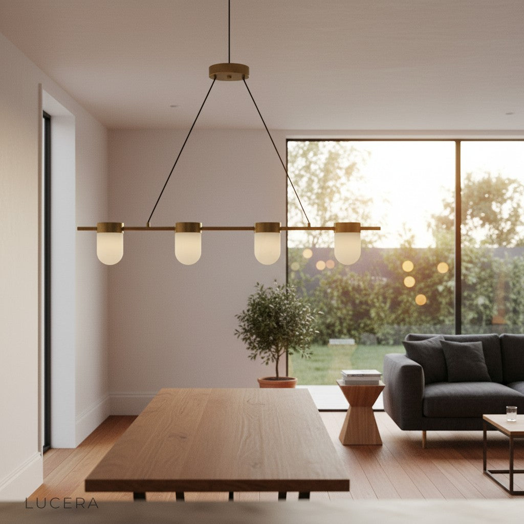 Nighttime lifestyle shot of linear chandelier casting warm glow in dark living room