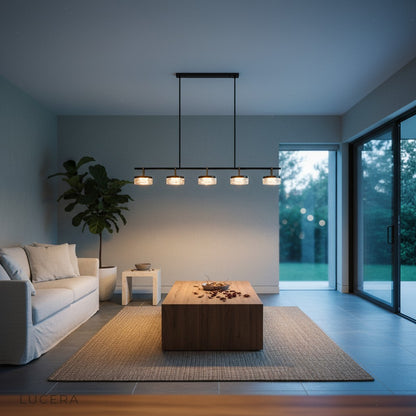 Aquamarine chandelier glowing at dusk over kitchen island with ambient shadows