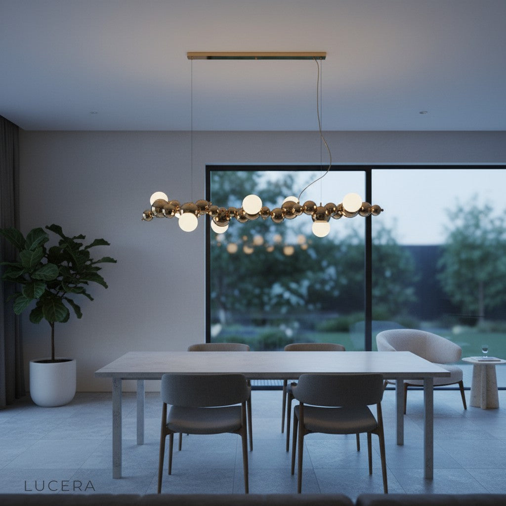 long bubble chandelier in brushed nickel above white marble table in bright breakfast nook