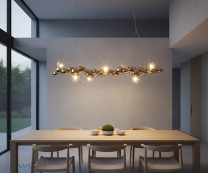 matte black chandelier with bubble shades illuminating a stylish entryway with high ceiling
