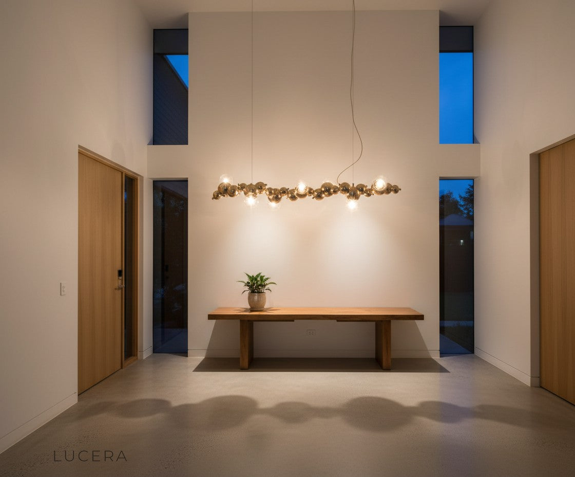 aesthetic moody shot of bubble glass chandelier reflecting in mirror above dark console table