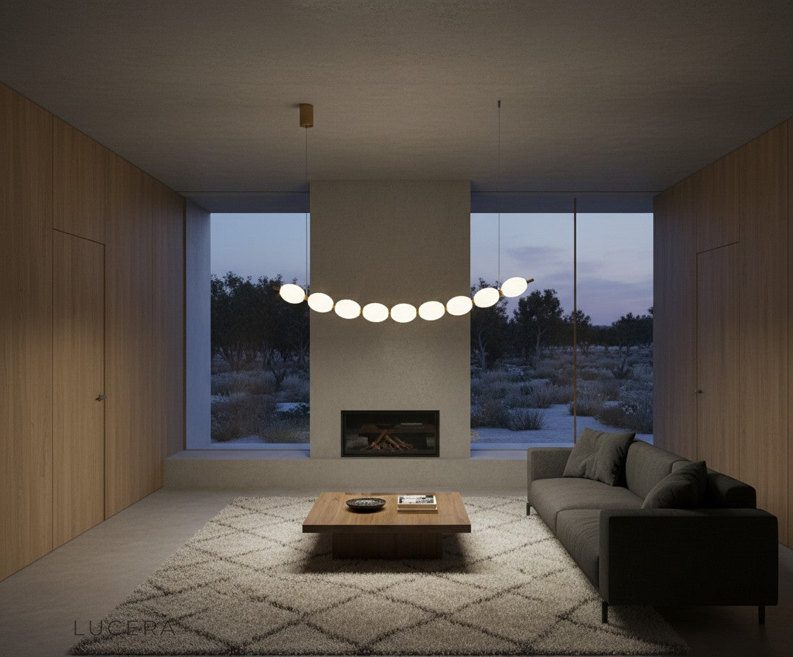 Nighttime lifestyle shot of chrome string of pearls pendant chandelier glowing in a stylish lounge with city view
