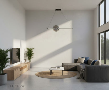 evening lifestyle shot of Bjorn chandelier illuminating a stylish lounge area with velvet sofa