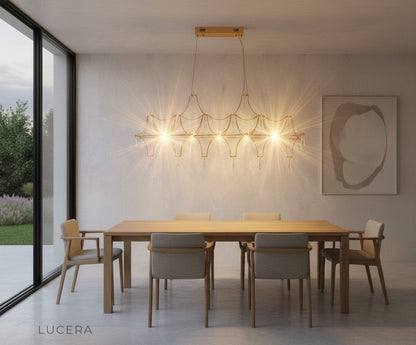 Leif chandelier in chrome finish above marble kitchen island with soft lighting