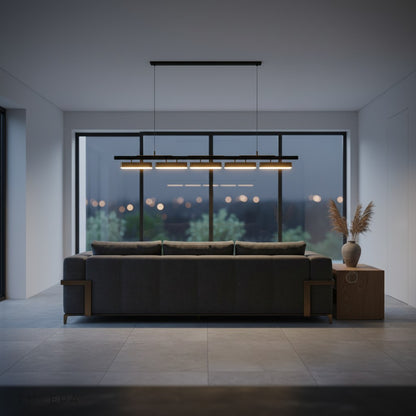 Oskar chandelier in a cozy reading nook with warm ambient light and bookshelf background