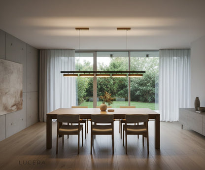 Nighttime lifestyle shot of Oskar LED chandelier casting geometric shadows on a white wall